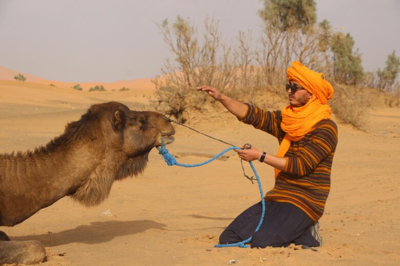 Authentic sustainable tourism experience in Morocco, showing responsible travelers engaging with local culture and preserving natural landscapes.